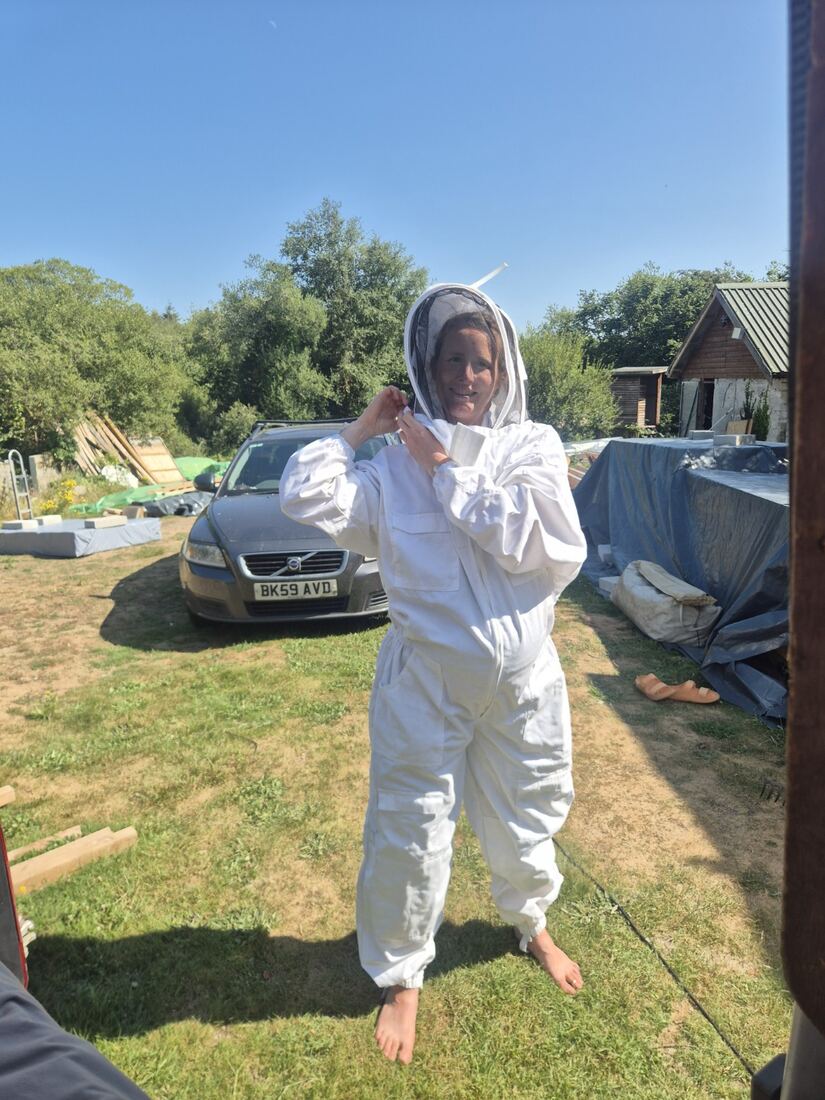 Beekeeper in a white suit at Ennal’s Pool