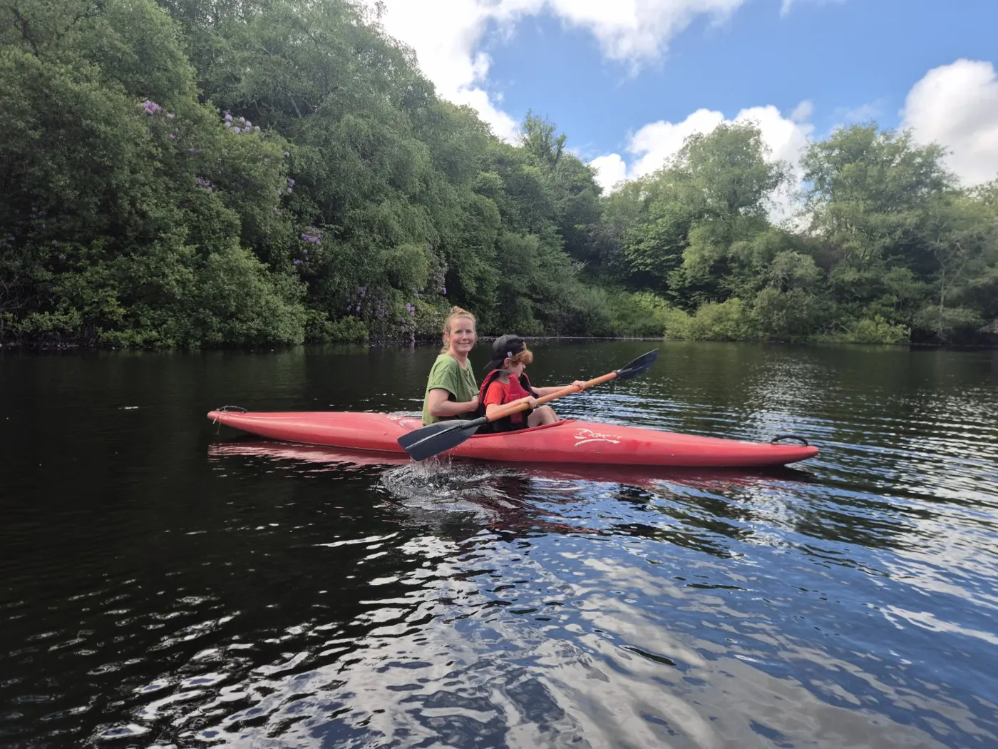 Two paddlers in a red kayak on Ennal’s Pool